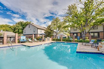 Resort style pool with hot tub and loungers